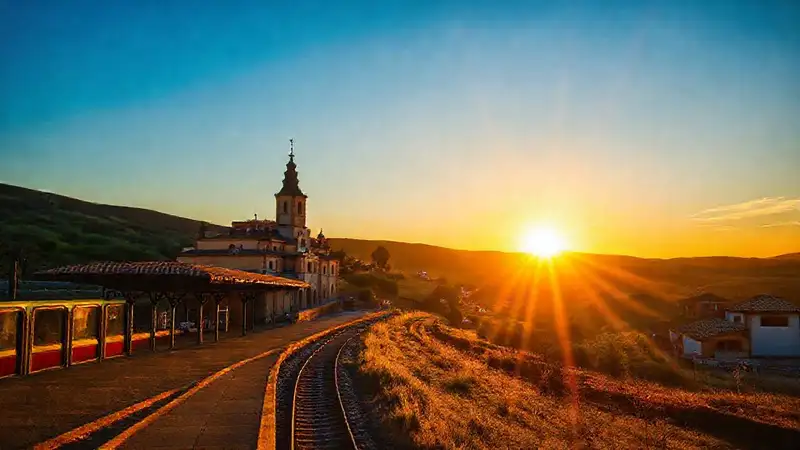 España: tren, monasterio y atardecer